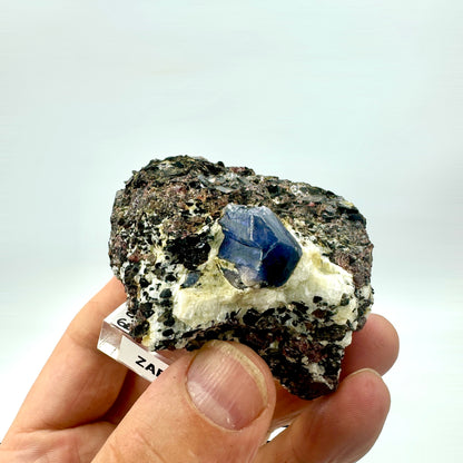 Blue sapphire in a garnet cluster